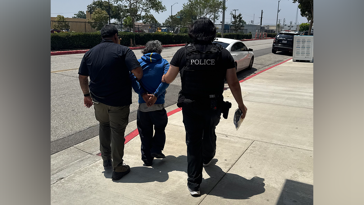 Arturo Terron-Quevedo being walked down the street by federal agents.