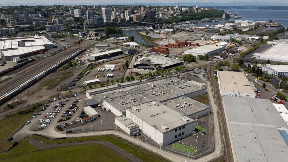 An aerial view of detainees exercising in an outdoor recreation area at the Northwest ICE Processing Center