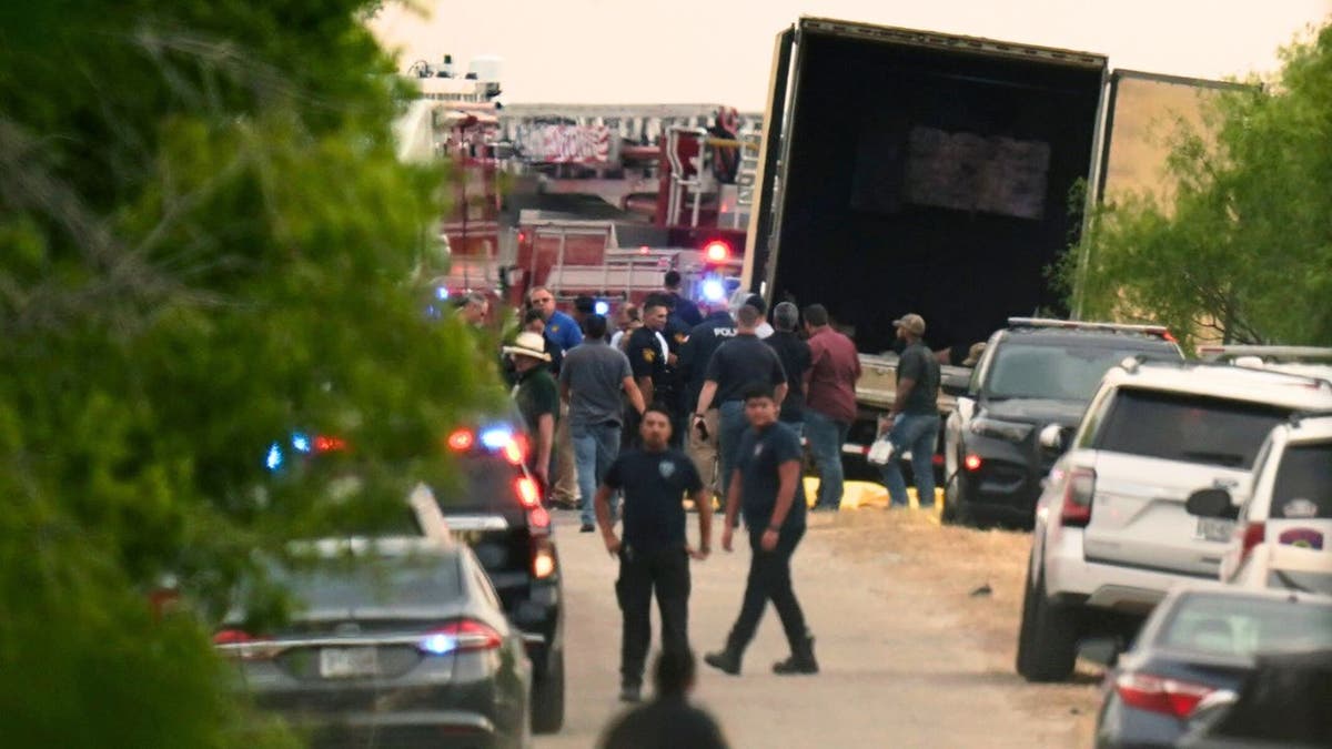 Body bags lie at the scene where a tractor trailer with multiple dead bodies was discovered, Monday, June 27, 2022, in San Antonio. 