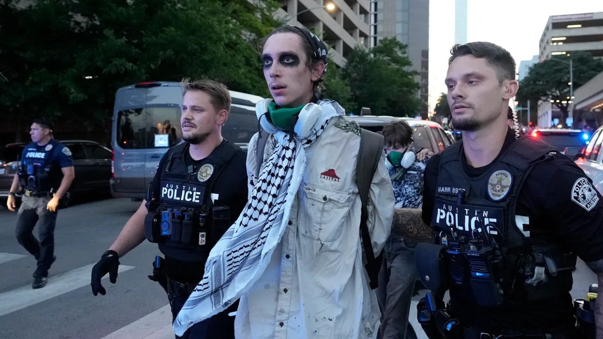 Police arrest a man outside the J.J. Pickle Federal Building at a protest in Austin to express opposition to federal immigration raids and show solidarity with demonstrators in Los Angeles Monday, June 9, 2025.
