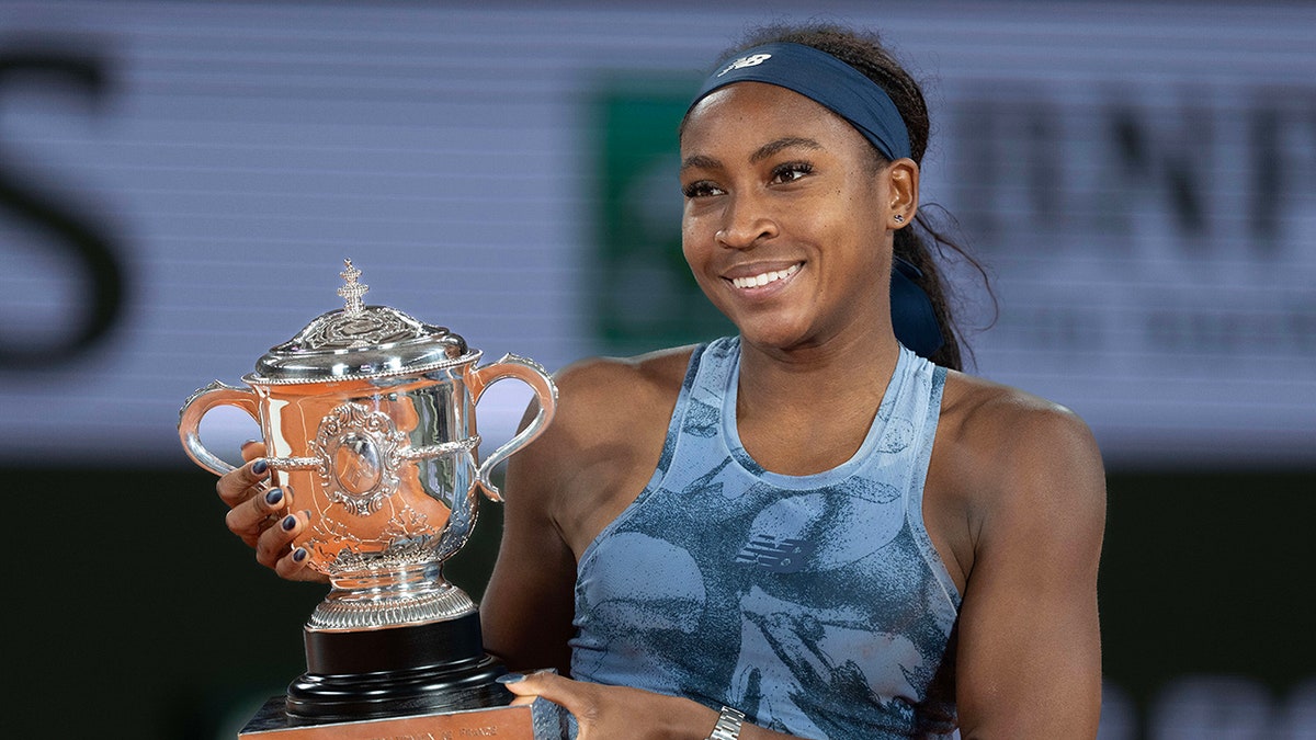 Coco Gauff smiles with trophy