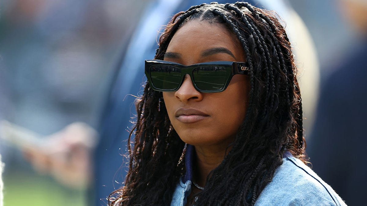 Simone Biles watches practice