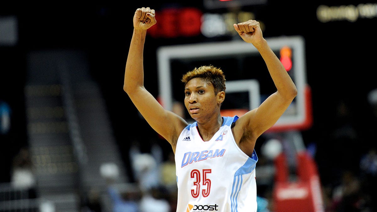Angel McCoughtry with her arms raised