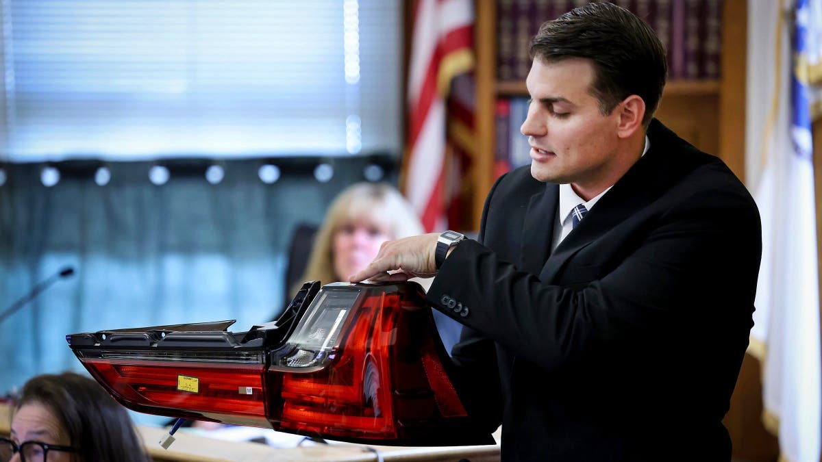Accident reconstruction specialist Dr. Daniel Wolfe holds an exemplar taillight