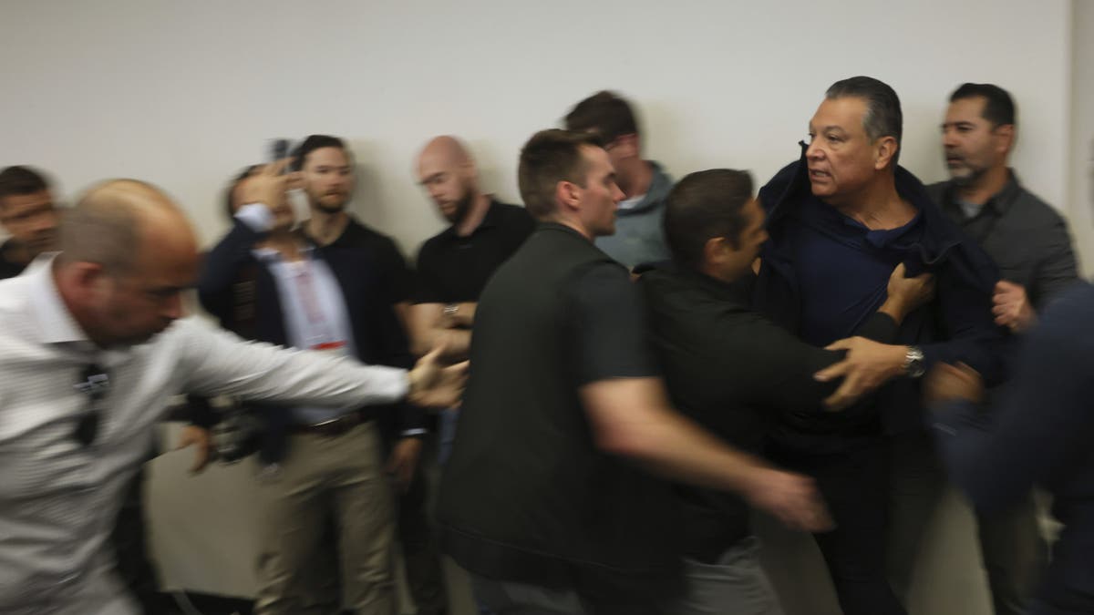 Sen. Alex Padilla, D-Calif., is pushed out of the room as Homeland Security Secretary Kristi Noem holds a news conference regarding the recent protests in Los Angeles on Thursday, Jun. 12, 2025.