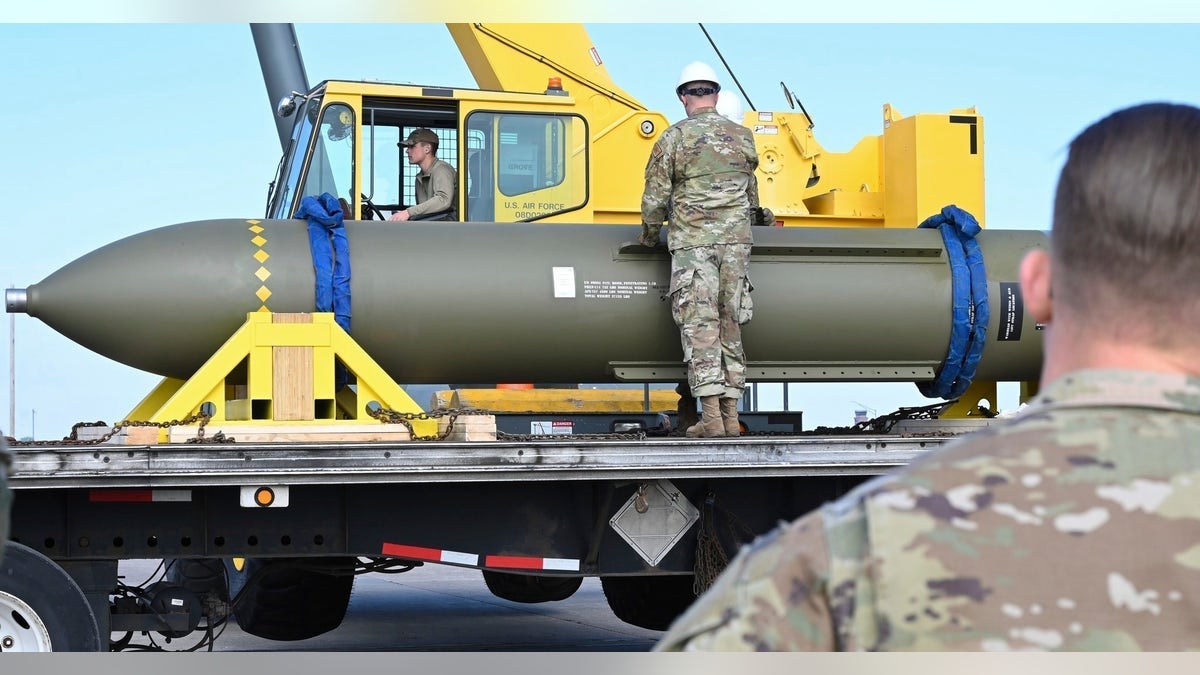 airmen moving a bomb