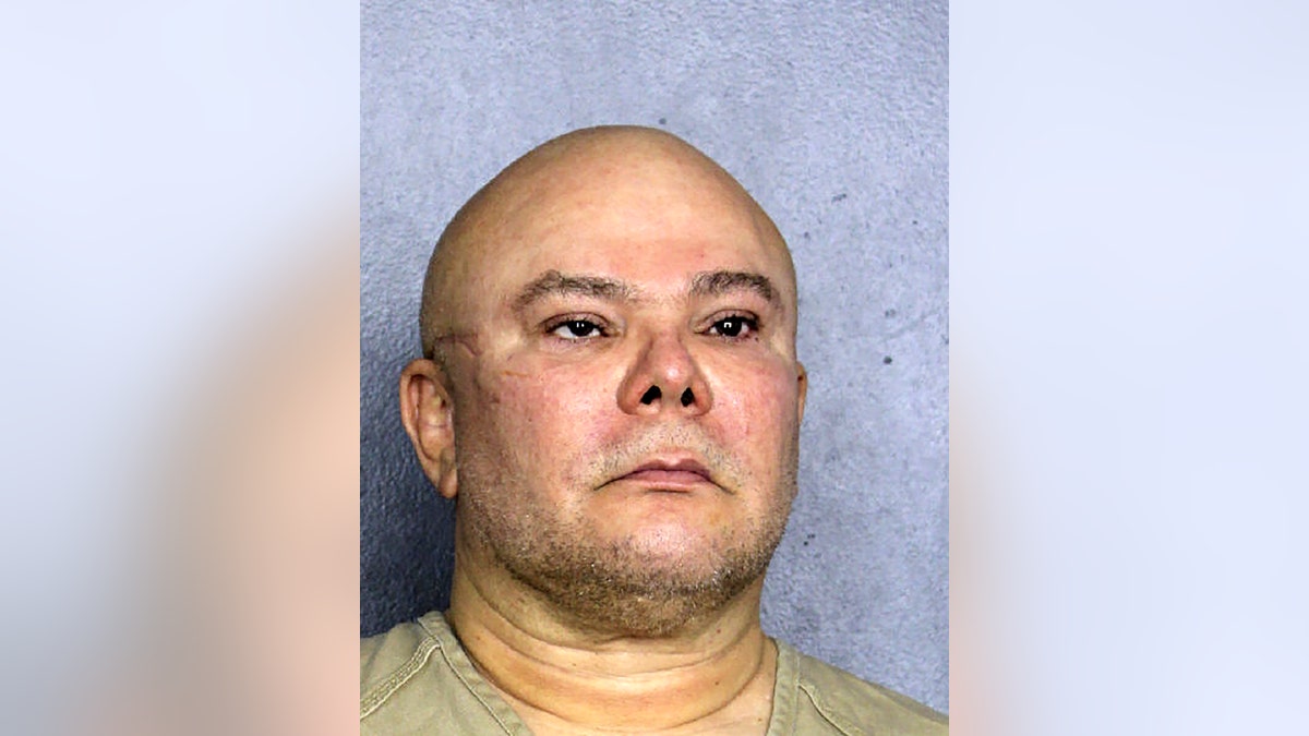 Jorge hernandez pictured in a mugshot, bald with stubble, her has a scar on the right side of his face and a lazy eye