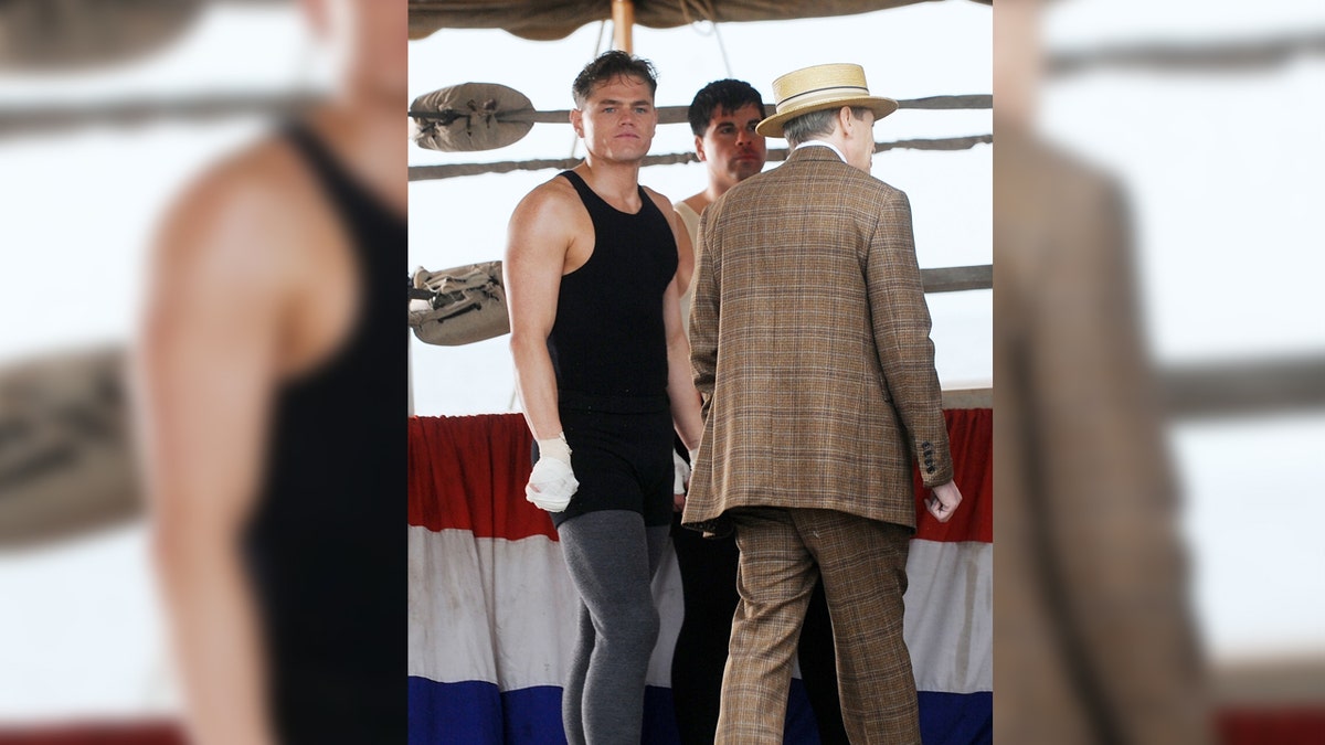 Devin Harjes wears vintage boxing uniform on set.