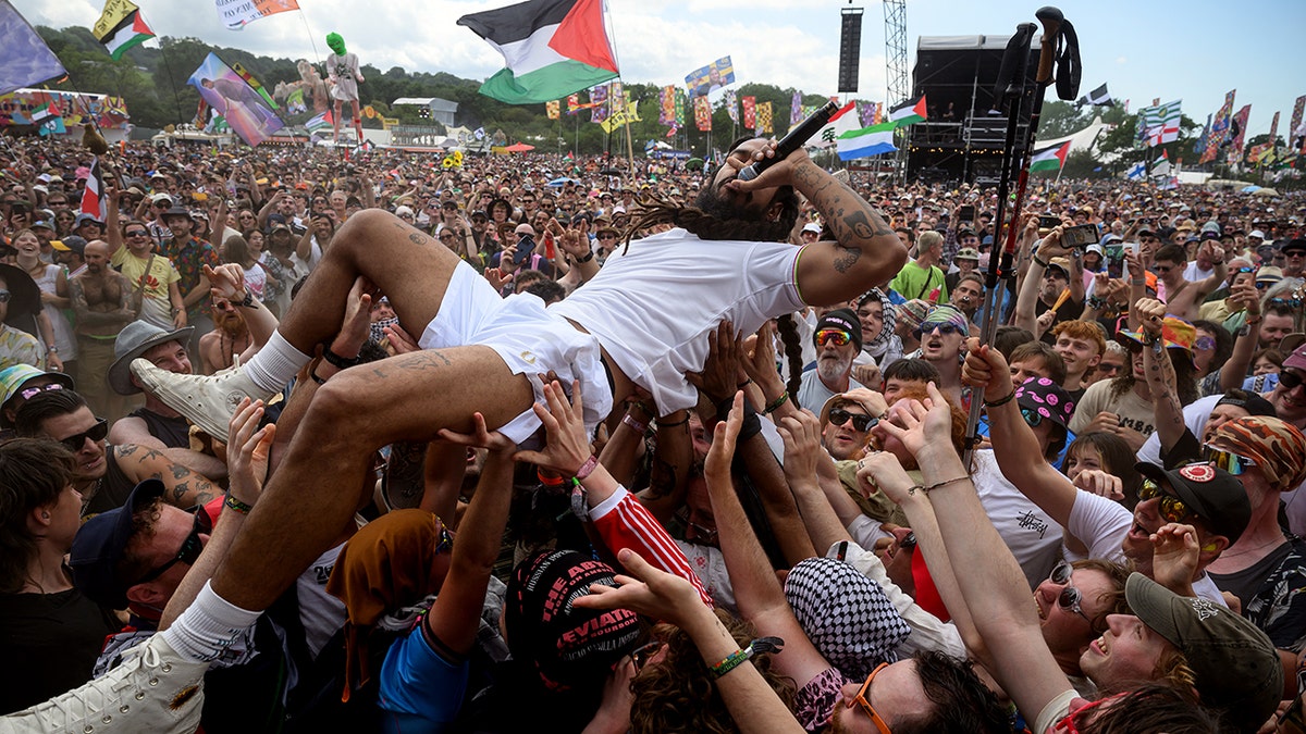 Bobby of Bob Vylan crowdsurfs at Glastonbury