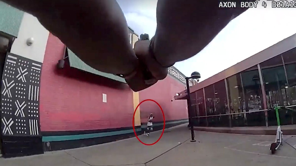 Policeman pointing a gun at the suspect