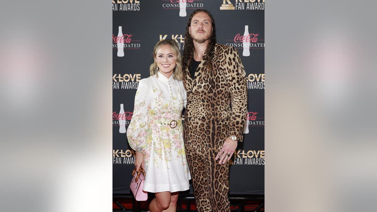 Brandon Lake with his arm around his wife at an event