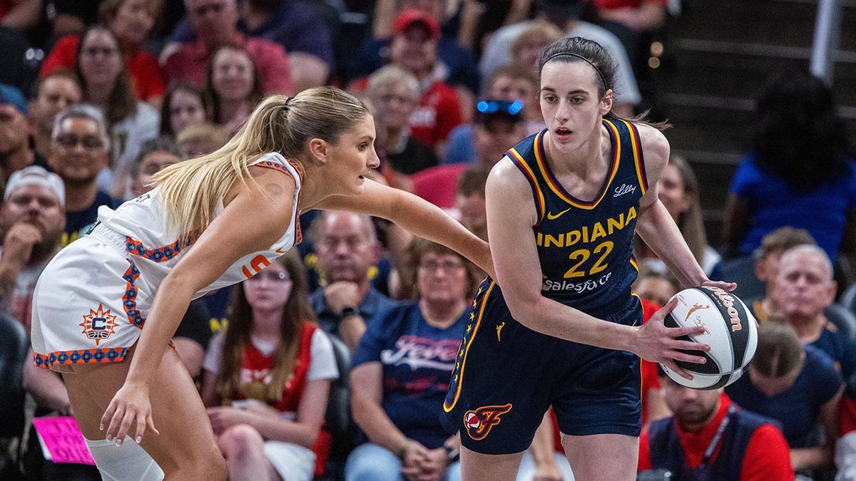 Jacy Sheldon drives on Caitlin Clark