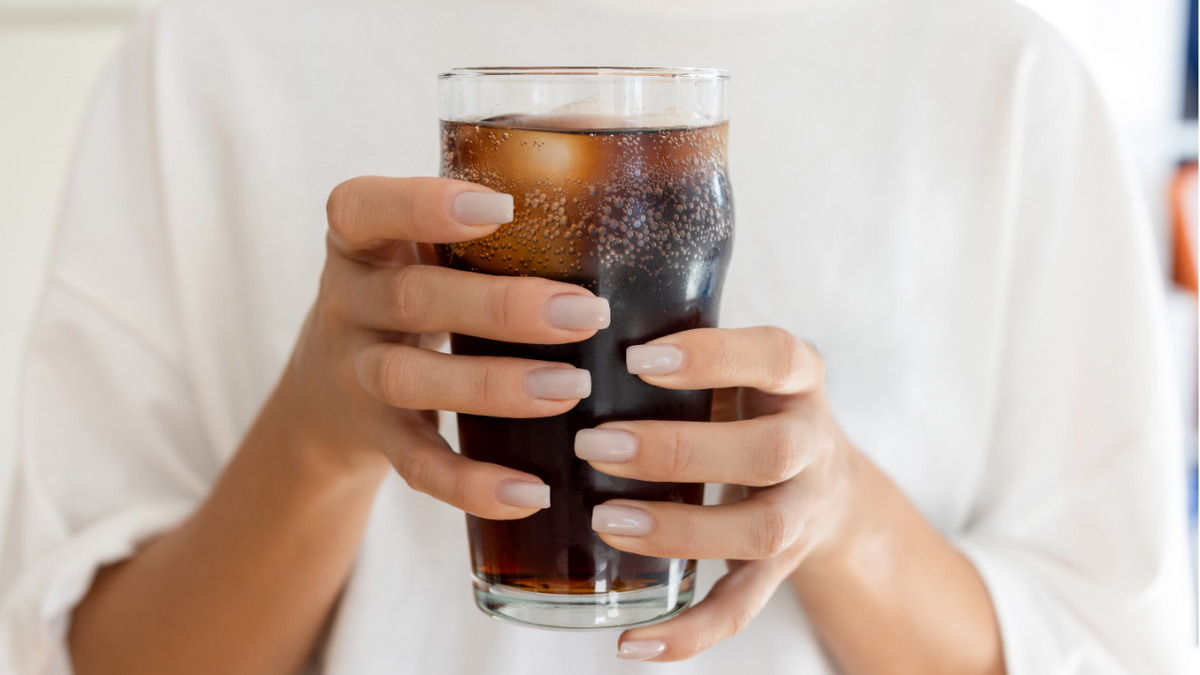 Hand holding soda