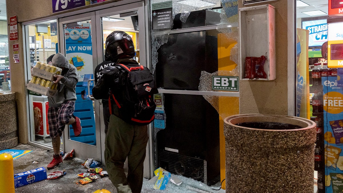 Looters break into a gas station's market place