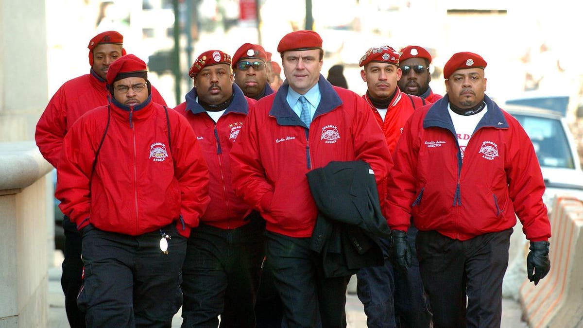 Curtis Sliwa is accompanied by members of the Guardian Angels