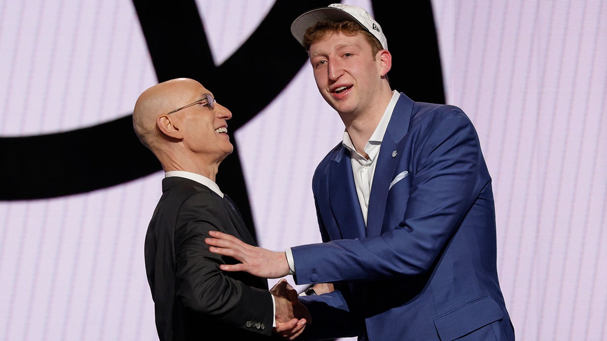 Danny Wolf shakes hands Adam Silver