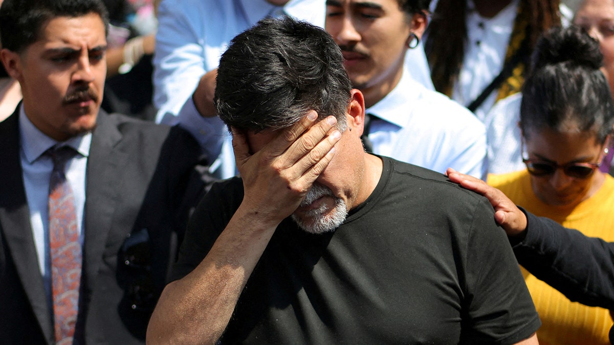 David Huerta with face in hand