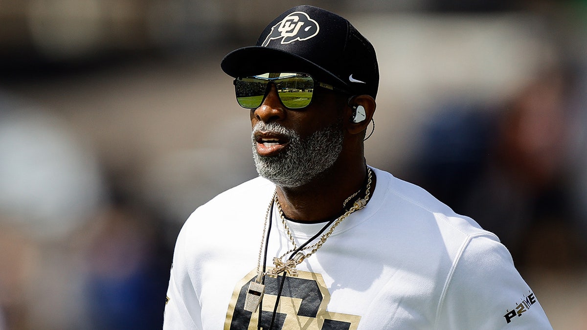 Deion Sanders looks on