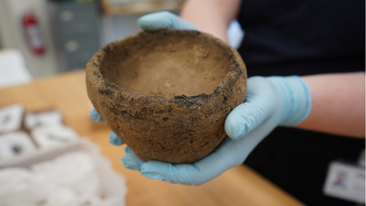 Archaeologist holding bowl