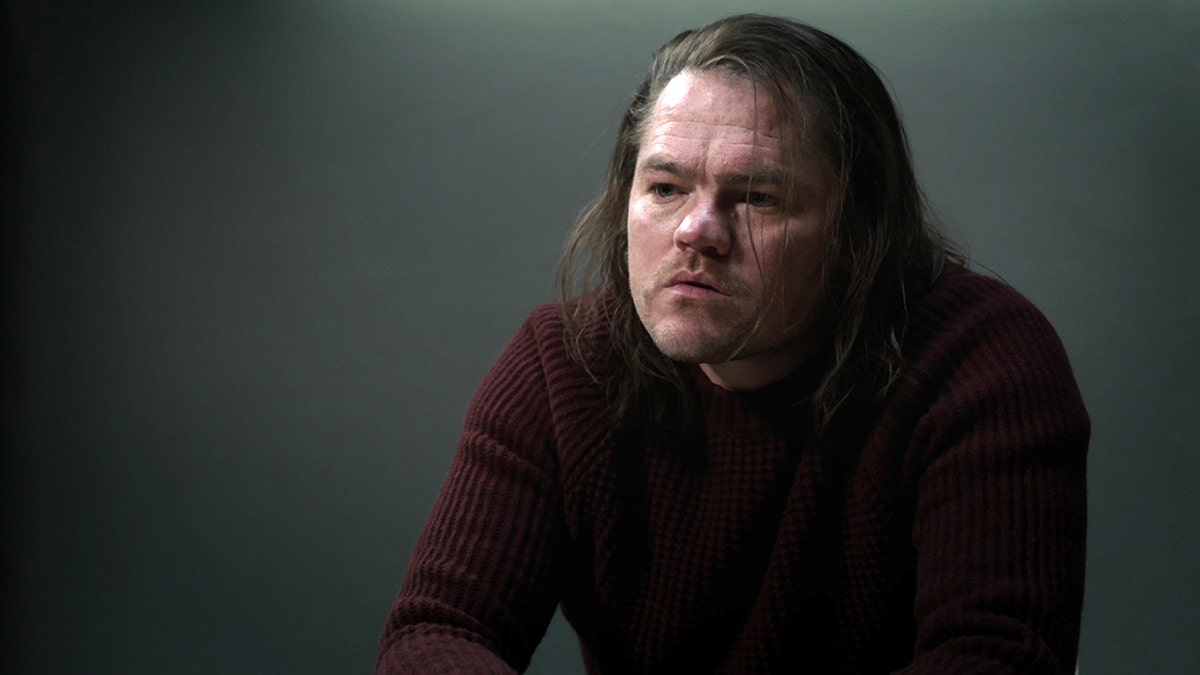 Devin Harjes wears a red sweater on Manifest.