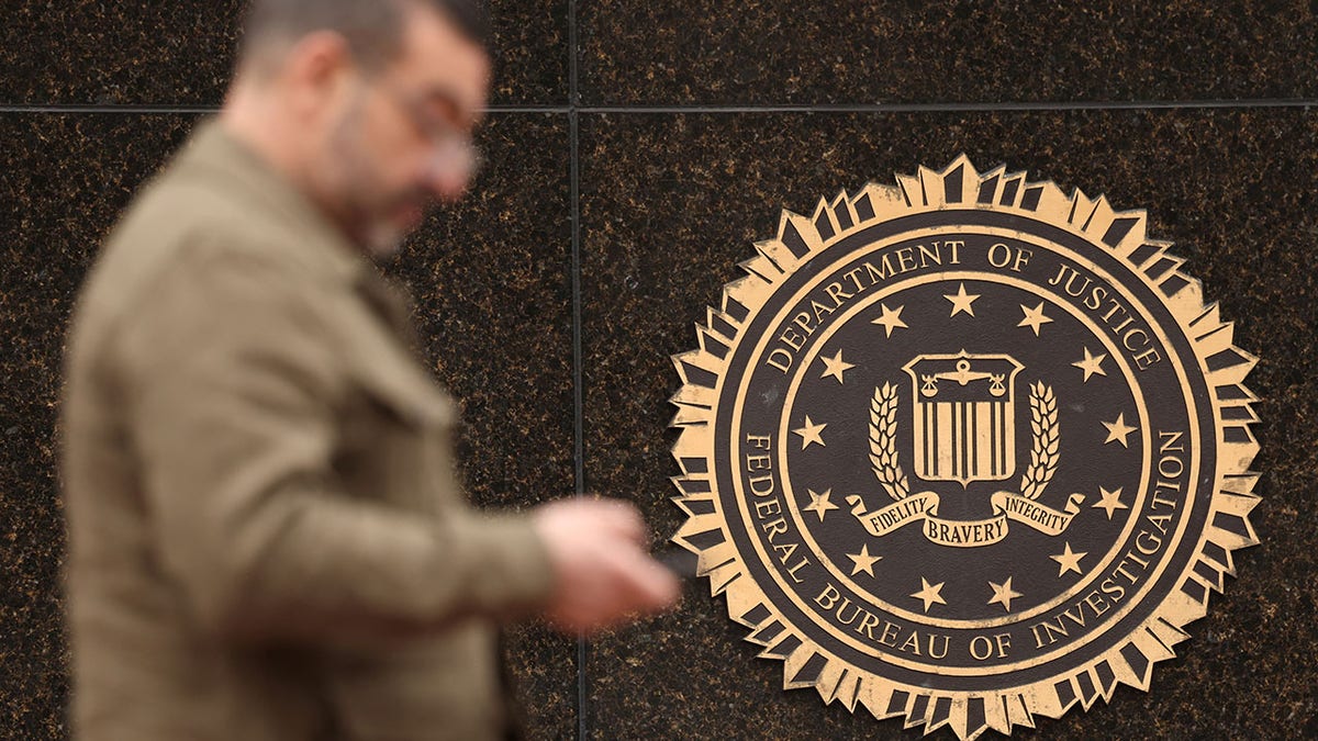 A man walks past a DOJ building