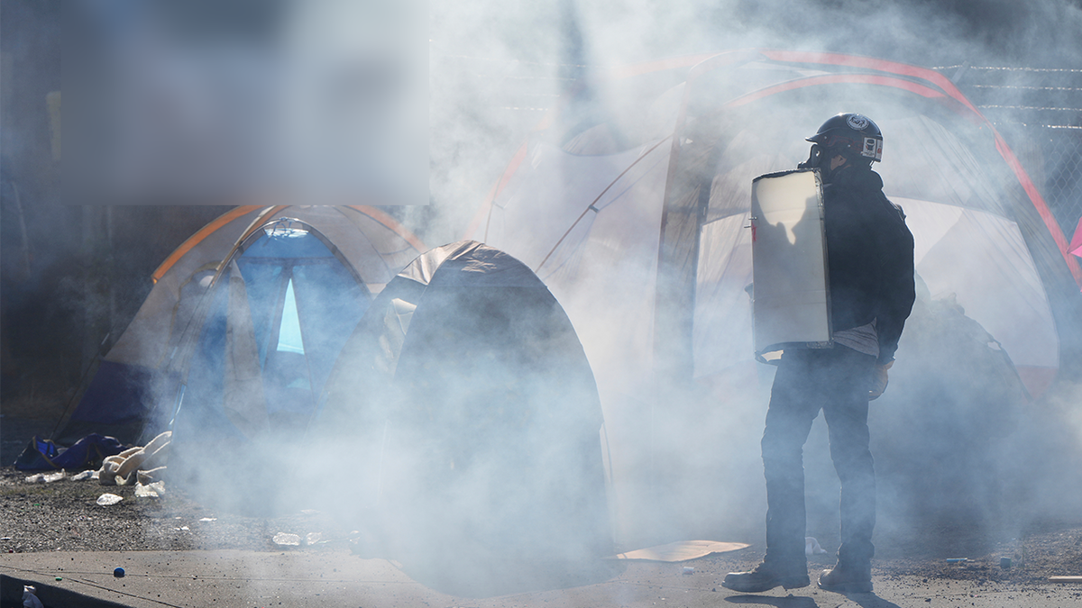 Tear gas surround tents outside the U.S. Immigration and Customs building during a protest Saturday, June 14, 2025, in Portland, Ore.