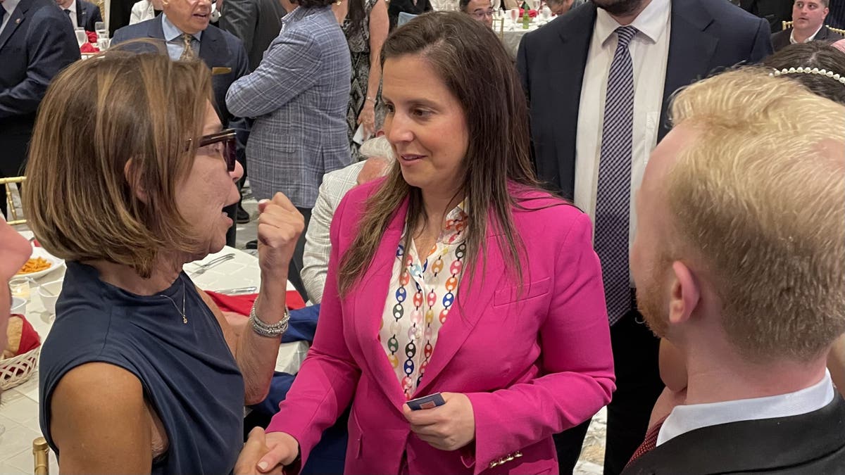 GOP Rep. Elise Stefanik of New York speaks with an attendee at a Staten Island GOP fundraising dinner on June 2, 2025, in New York City.