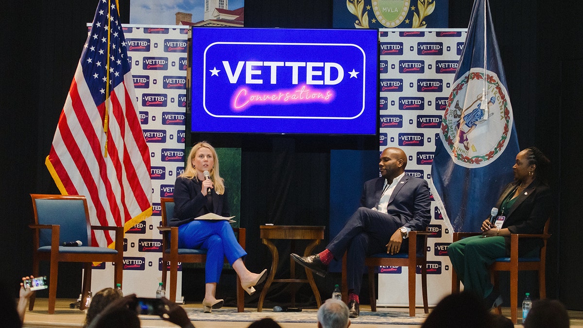 Ellen Gustafson moderates a civic panel with two speakers during the 