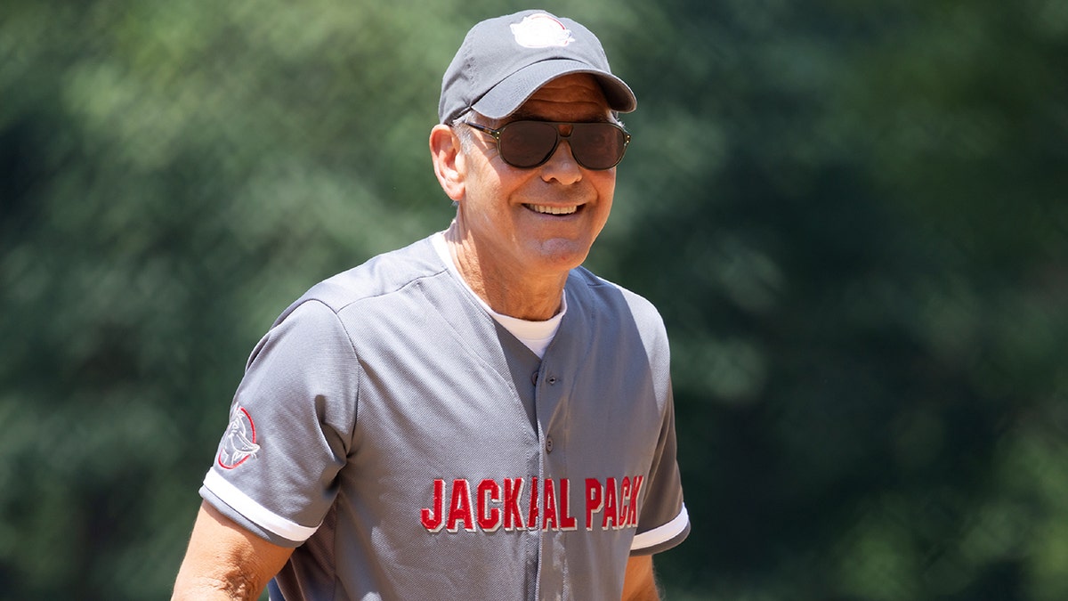 George Clooney wears hat while playing softball
