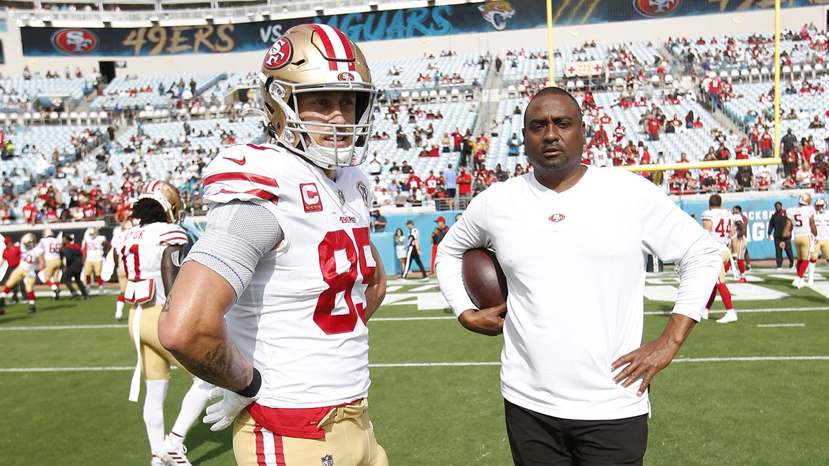 George Kittle and Jon Embree on field