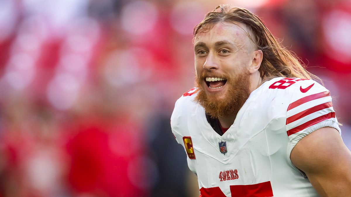 George Kittle runs onto the field