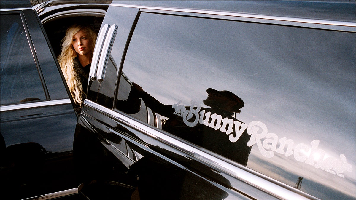 A woman outside the limousine.