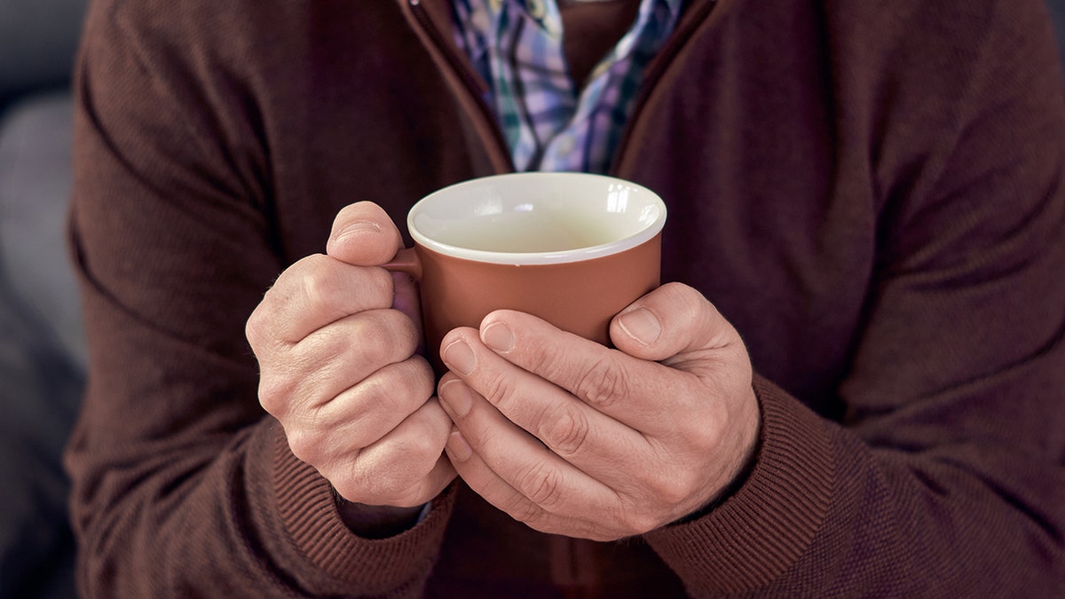 Man holding teacup, close shot