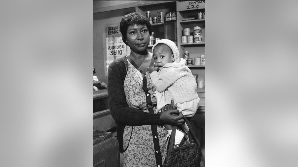 Lynn Hamilton holding baby in The Waltons