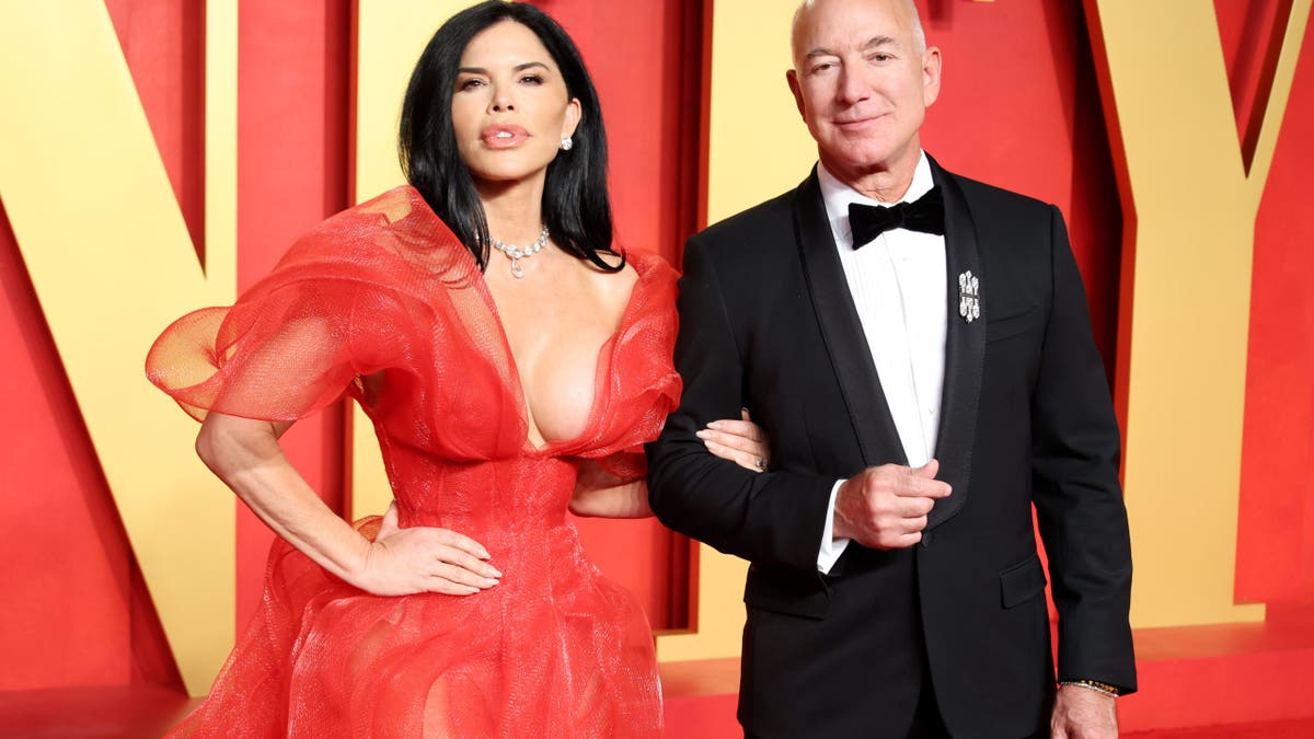 Lauren Sanchez successful a reddish gown with Jeff Bezos successful a tuxedo connected reddish carpet
