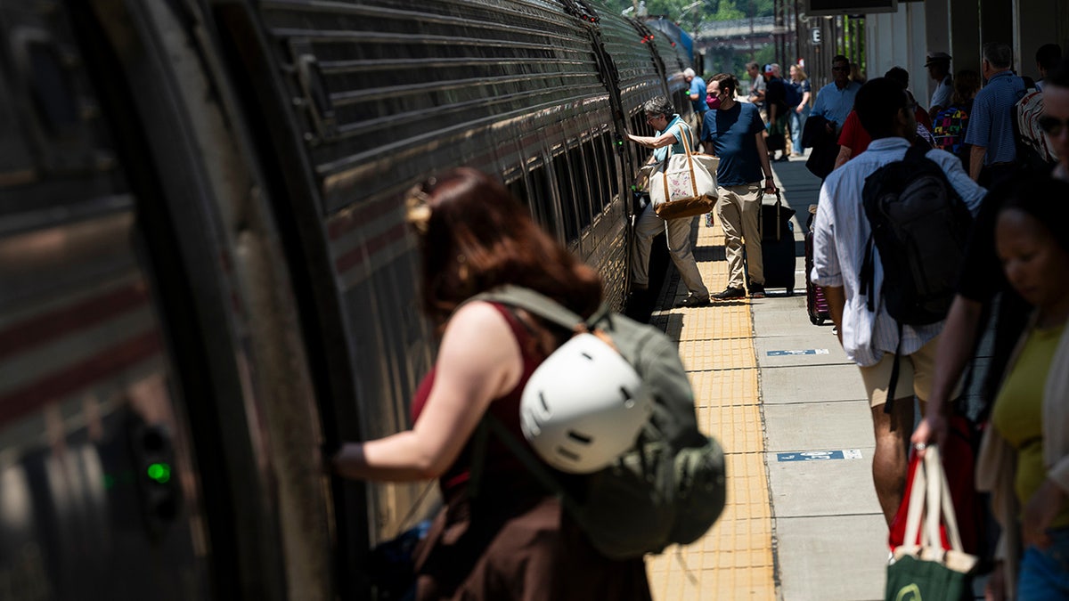 travelers board amtrak train