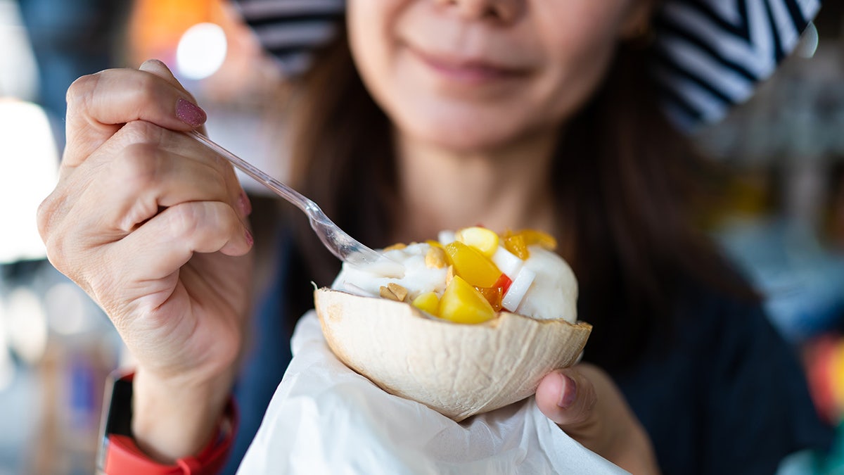 woman enjoying ice cream with mango