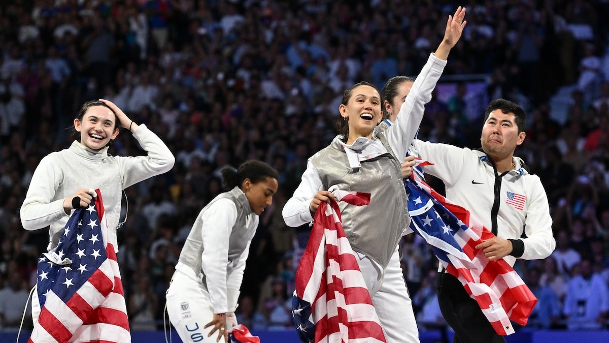 Lee Kiefer, Lauren Scripugs, Maia Mei Weintraub and Jacqueline Dubrovich of the United States team with gold medals at the end of the women's frustration team final on the sixth day of the Paris 2024 Olympic Games at Grand Palais on August 1, 2024, in Paris, France.