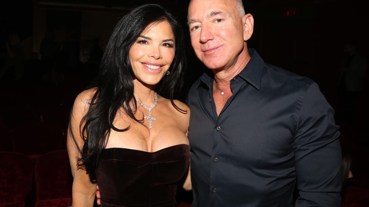 Lauren Sanchez and Jeff Bezos grin portion posing for a photo