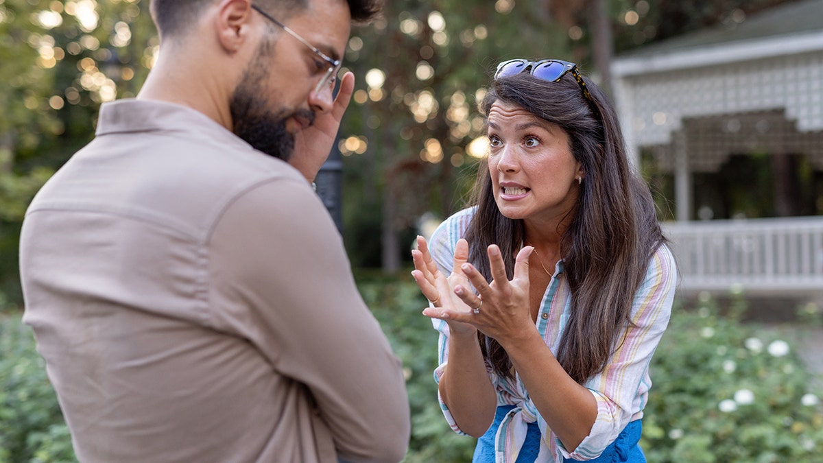 woman argues with man outside