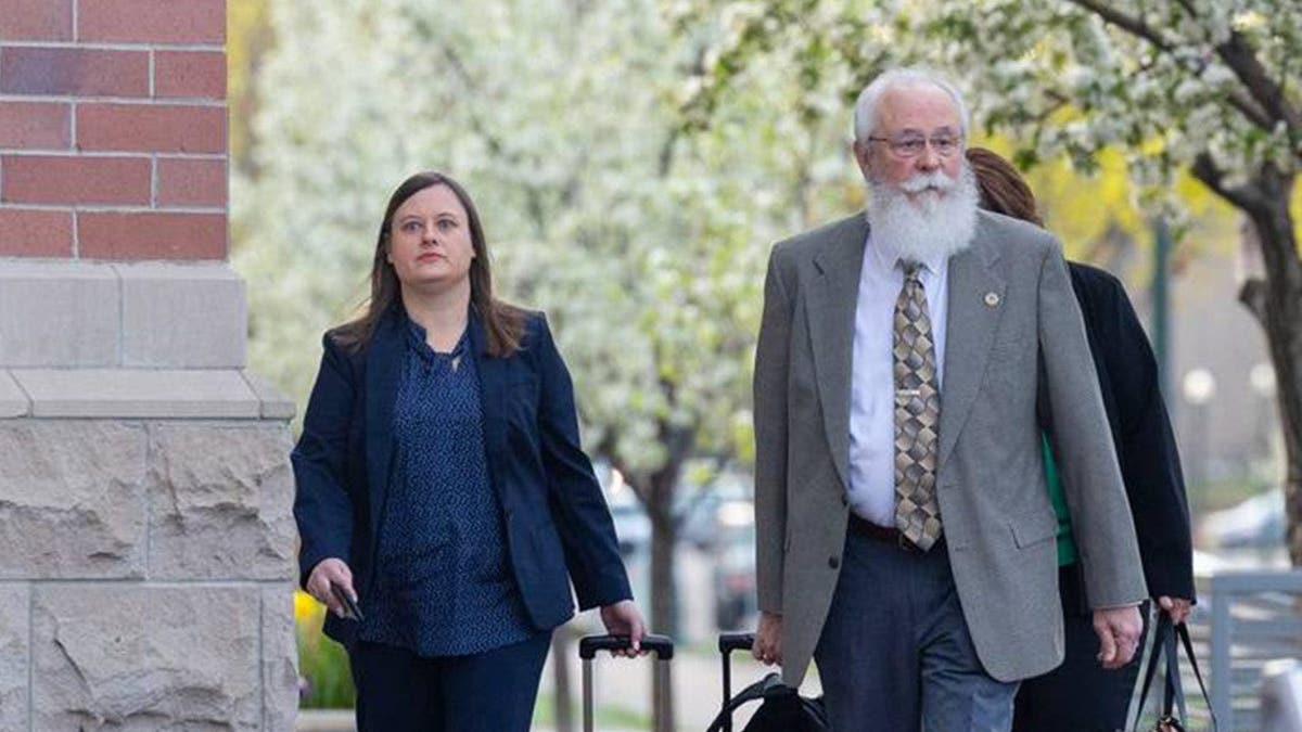 Latah County Senior Deputy Prosecutor Ashley Jennings, left, and Latah County Prosecutor Bill Thompson, right, carrying briefcases full of court paperwork