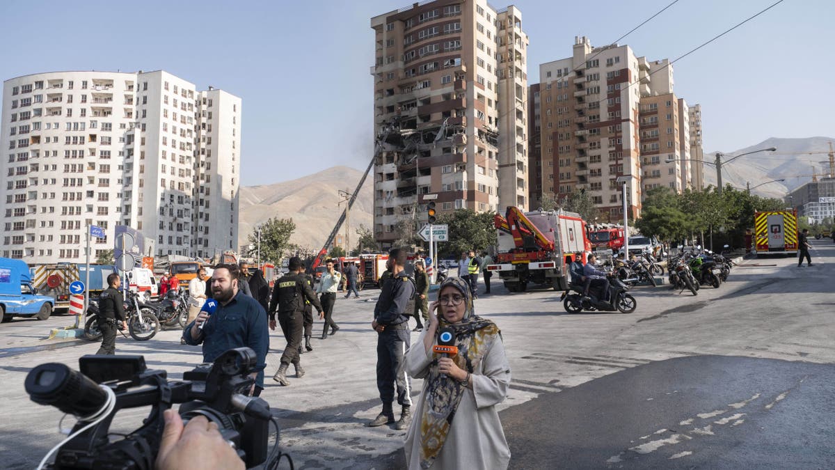 Iranian reporters report from the scene of an explosion at a residential complex due to Israeli attacks in Tehran, Iran, on June 13, 2025.