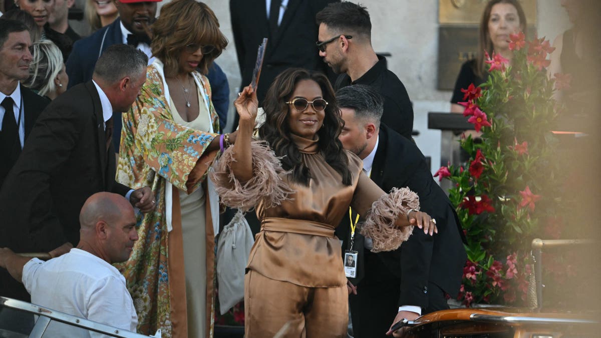 oprah winfrey waves as she and gayle king head to a party after jeff bezos and lauren sanchez's wedding