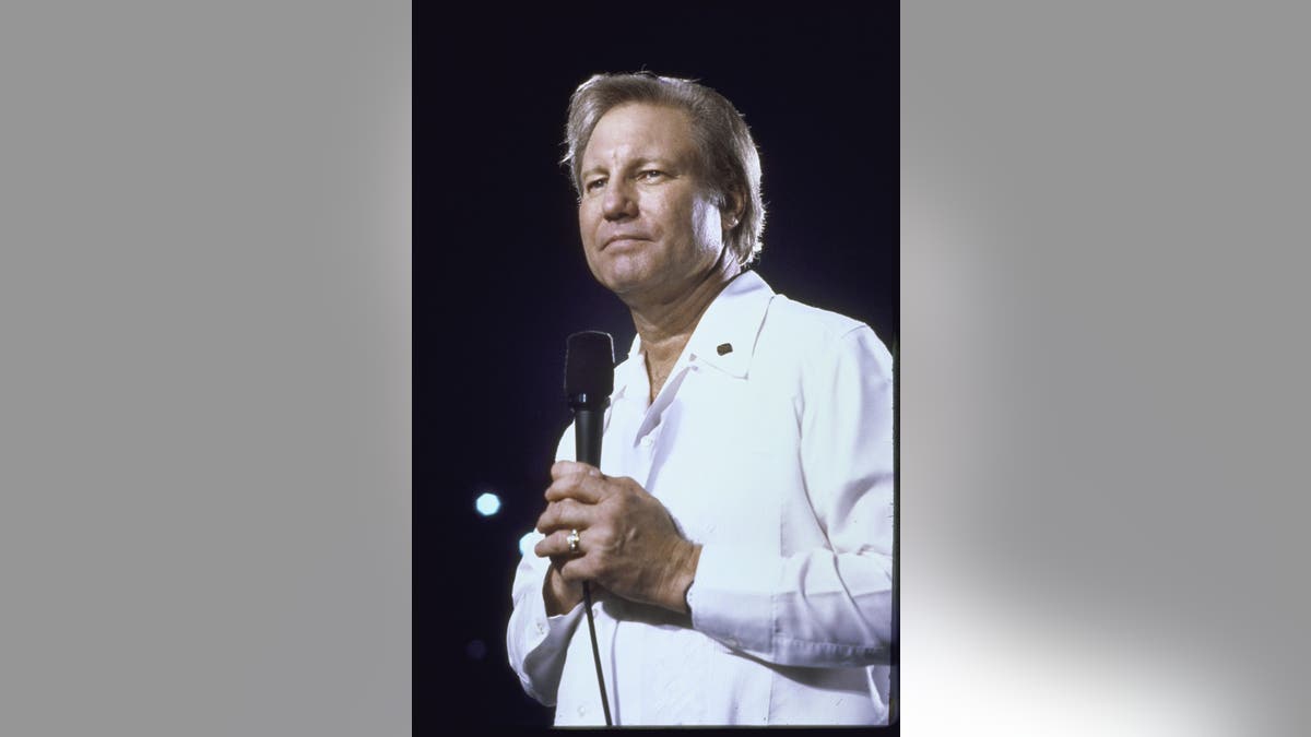 Rev. Jimmy Swaggart holding a microphone