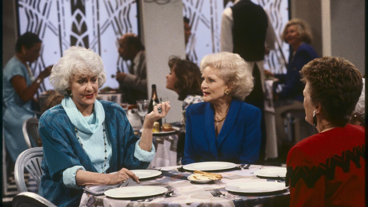 bea arthur, bette white, rue mclanahan sitting at a table in golden girls 