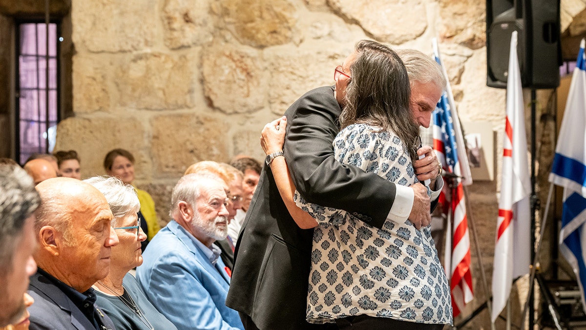 Franklin Graham hugs Karina Engel
