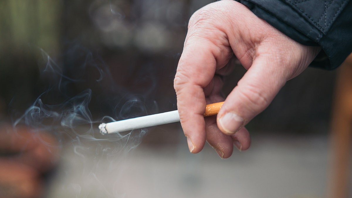 Person holding cigarette, Concept Quitting smoking, World No Tobacco Day