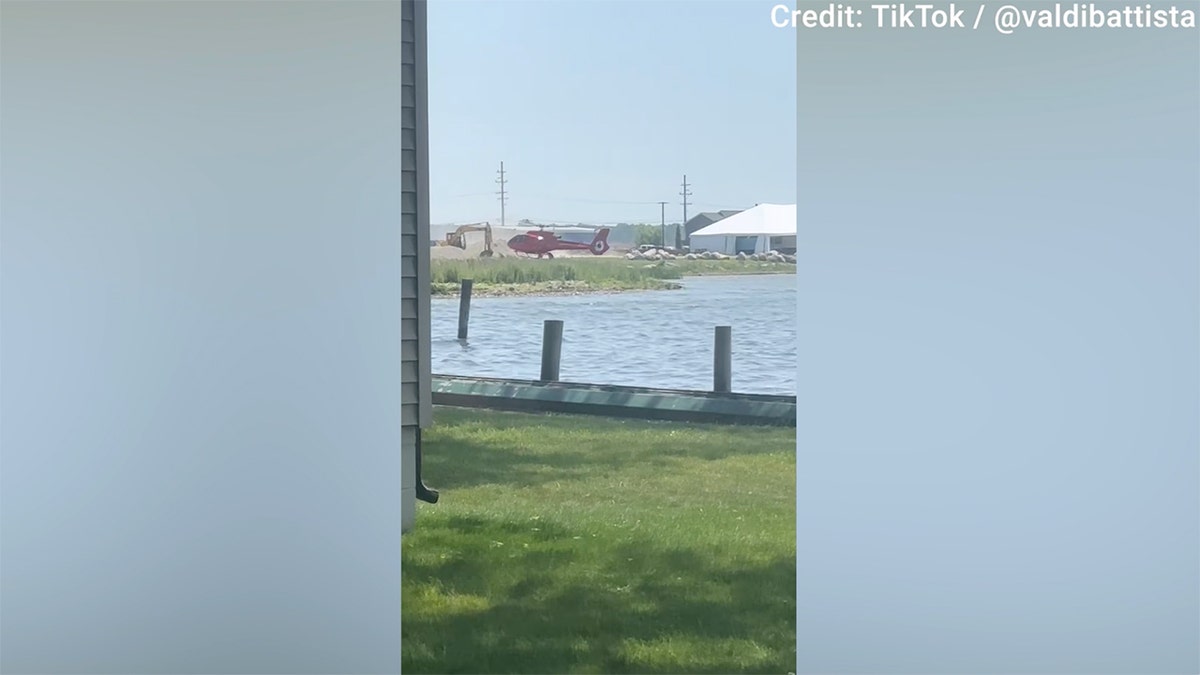 The helicopter appeared to be trying to land when it flipped in Michigan on Sunday.