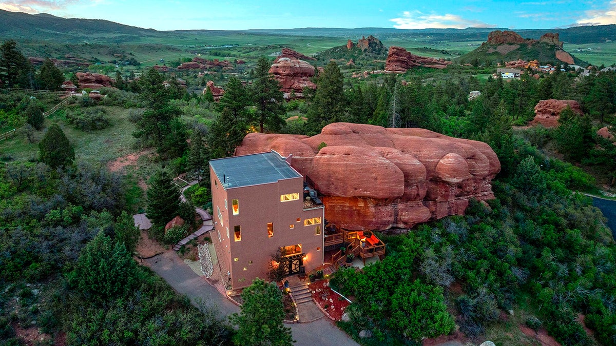 Check out this real-life Flintstones home built around a 200 million-year-old red rock. The two-bedroom house in Larkspur, Colorado, US, has a very unique style - perfect for a Flintstone fan. The property - nicknamed the rock house - is integrated with nature, nestled around a 45ft high section of one of Colorado's beloved 200-million-year-old red rocks. On the market for $1m, the property "transforms nature's artistry into a one-of-a-kind architectural statement". The property boasts walking trails, a picnic area, Milky Way views from the private hot tub, and all the peace and serenity a homeowner could wish for.