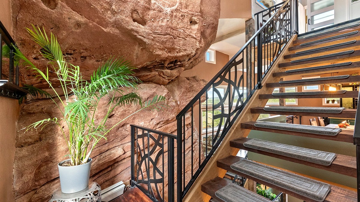 Check out this real-life Flintstones home built around a 200 million-year-old red rock. The two-bedroom house in Larkspur, Colorado, US, has a very unique style - perfect for a Flintstone fan. The property - nicknamed the rock house - is integrated with nature, nestled around a 45ft high section of one of Colorado's beloved 200-million-year-old red rocks. On the market for $1m, the property "transforms nature's artistry into a one-of-a-kind architectural statement". The property boasts walking trails, a picnic area, Milky Way views from the private hot tub, and all the peace and serenity a homeowner could wish for.